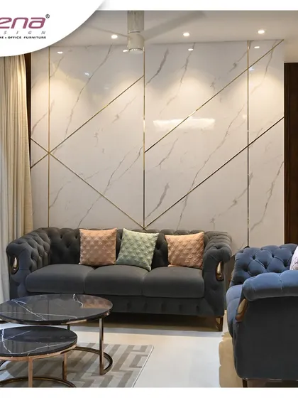 This living room setup features a classic Chesterfield sofa against a wall with modern geometric paneling. The combination of the timeless sofa design and the contemporary wall treatment creates a unique and stylish look.