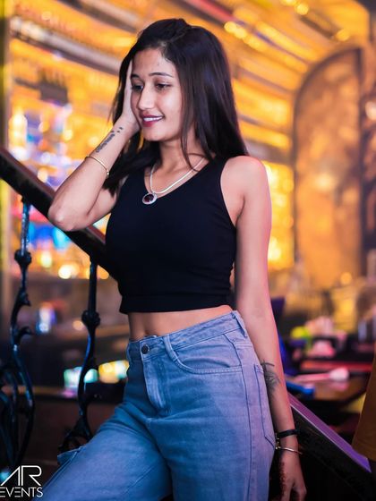 A guest posing on the stairs of the venue.