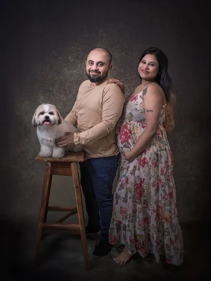 A classic studio portrait of an expecting couple with their beloved Shih Tzu. This session was about formally capturing their family of three before the new baby arrived.