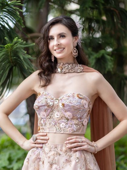 The complete ensemble is a vision of modern elegance. The soft makeup ensures that the focus remains on the bride's happy, radiant face.