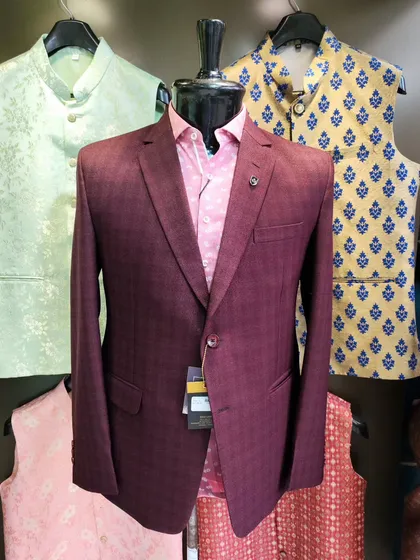 A collection of our designer suits, showcasing a variety of colors, fabrics, and custom details like embroidery, unique lapels, and accessories. Each piece is crafted to make a lasting impression.