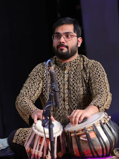 Another angle from the same concert, showing the physical and mental engagement of playing tabla.