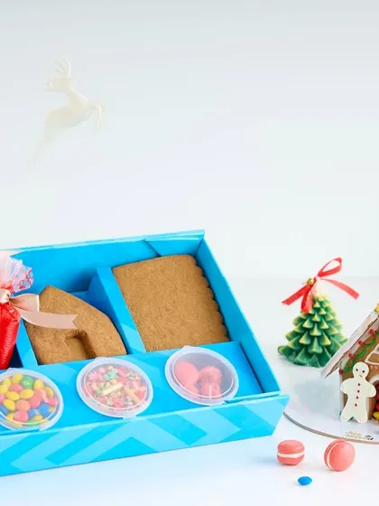 Our DIY Gingerbread House kit is a favorite holiday activity. The box includes everything you need to build and decorate your own edible house, complete with gingerbread panels, icing, and candy decorations.