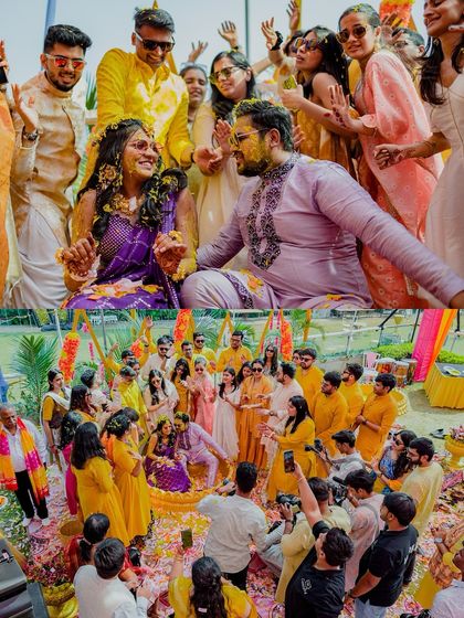 The couple surrounded by their friends and family, all joining in the fun of the Haldi ceremony.