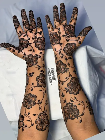 This is a beautiful example of a flowing floral vine design, perfect for guests who want an elegant pattern that travels up the arm. It's less dense than a full bridal design but still incredibly detailed and eye-catching for any celebration.