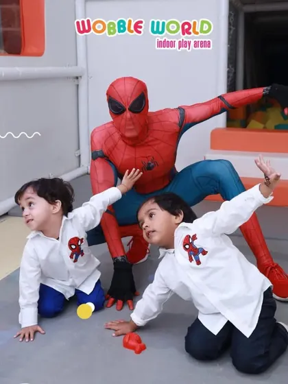 Two young boys strike a Spiderman pose alongside their hero. Our mascots are great at interacting with the kids and making them feel like part of the action.