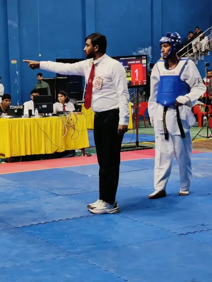 Giving instructions to a competitor during a match. Clear communication is key to good refereeing.