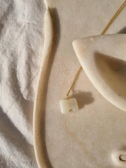 A final, clean look at the white moonstone elephant pendant, a charm for manifesting your dreams.