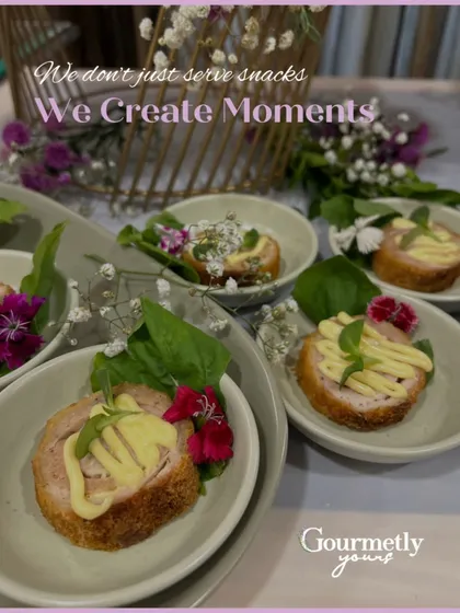 We don't just serve snacks, we create moments. This image features our individually plated chicken cordon bleu bites, designed to start conversations.
