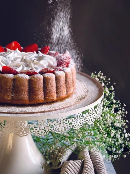 I believe dessert making is an art form. This image captures the final touch on a fresh strawberry cake, dusting it with powdered sugar to create a simple yet elegant finish. It’s a perfect example of how I turn fresh, seasonal ingredients into a beautiful dessert.