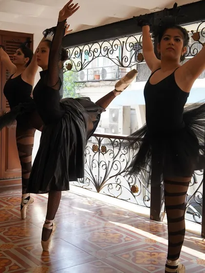 Practicing their arabesques in costume. We ensure our dancers are comfortable and confident moving in their full stage attire before the show.