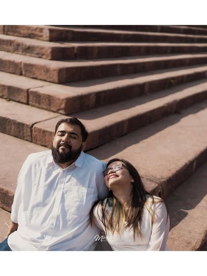 Soaking in the sun on the steps of Jama Masjid. This relaxed portrait captures a peaceful moment during their bustling city shoot.