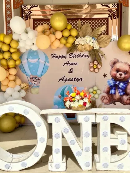 A detailed view of the teddy bear backdrop, showing the 'ONE' marquee letters and balloon arrangement.