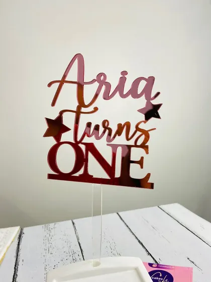 Our rose gold mirror finish is a customer favorite for a reason. This "Aria Turns ONE" topper shows how the warm, pinkish hue adds a modern and stylish touch to any birthday celebration.