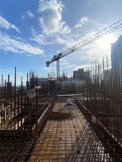 Another view from the construction site of the Skyline project in Bhayander. The silhouette of the crane against the sun and the dense grid of rebar illustrate the beauty and complexity of the construction process.