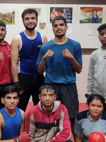 The evening training team posing for a group photo. We are a diverse group of male and female boxers united by our passion for the sport and our drive to succeed.
