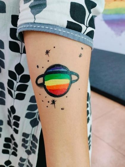 A colorful planet tattoo, perfect for a space-themed party or for any child who loves astronomy. Our artists are skilled in detailed work.