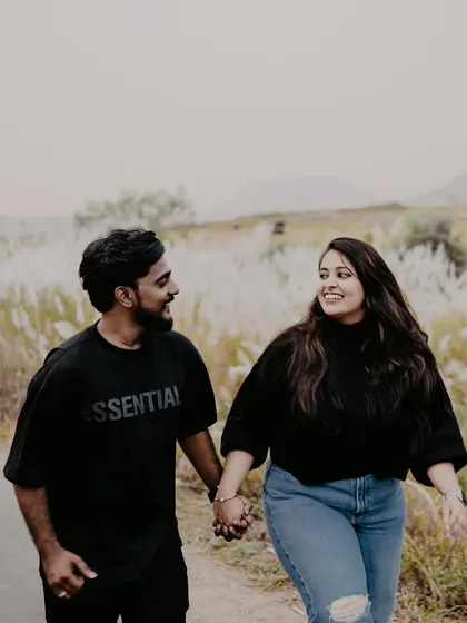 A casual and fun shot of a couple walking down a country road. Their relaxed outfits and happy interaction make this feel like a snapshot from their real life.