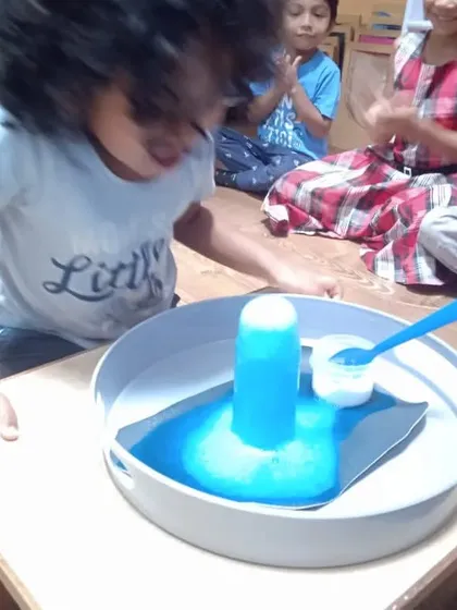 The look of pure wonder says it all. Our hands-on science experiments, like this mini volcano, are designed to spark excitement and curiosity. We make abstract concepts tangible, encouraging children to ask questions and discover the magic of science.