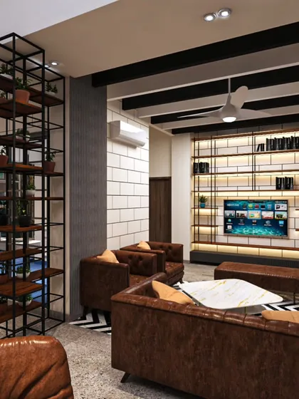 An industrial-chic lounge area designed for a modern office. We used a mix of exposed brick-style walls, metal shelving, and comfortable leather furniture to create a relaxed yet professional atmosphere, perfect for team brainstorming or client meetings.