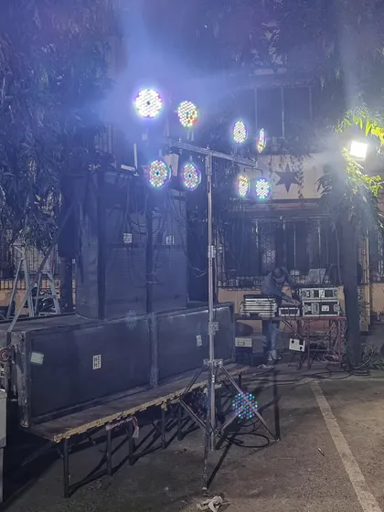 My full outdoor DJ setup for a Kojagiri Purnima event. This includes a large stack of speakers, a lighting truss, and my mixer and console, all ready for a night of music under the full moon.
