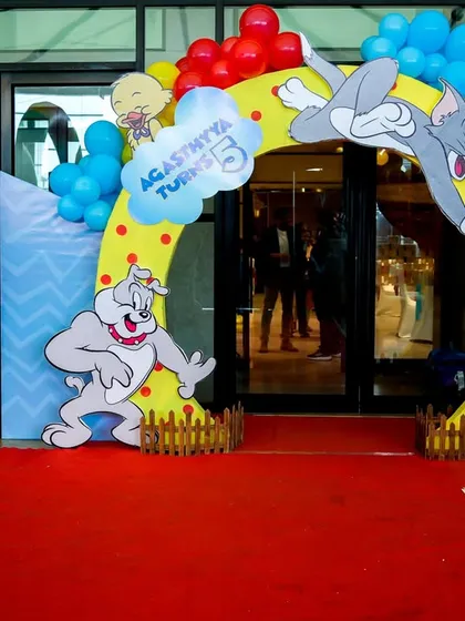 The party starts at the entrance. We create grand, immersive entryways like this Tom & Jerry arch, complete with a red carpet, that make guests feel like they're stepping right into the cartoon.
