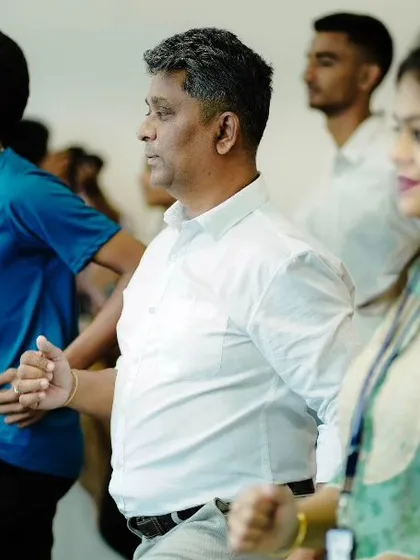 A group of engaged participants during a corporate yoga event. Creating a supportive and focused environment is key to helping employees disconnect from work stress and reconnect with their bodies and minds.