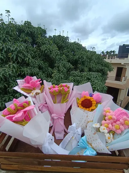 A collection of five different custom-wrapped pink bouquets.