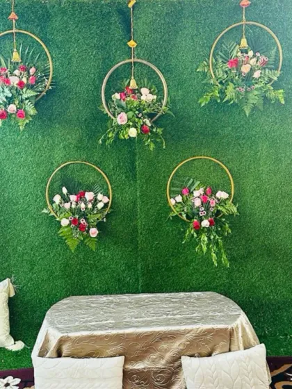 The full setup for the floral hoop Mehendi backdrop. The design includes a small table and comfortable floor seating with cushions, creating a perfect spot for the ceremony.