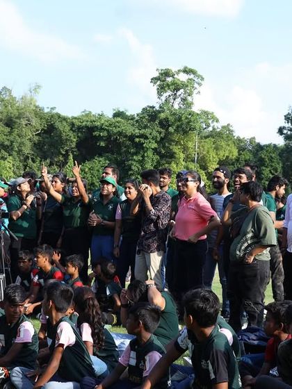 The audience of children and volunteers at the Citizen's Cup, enjoying the music. It was a meaningful day of combining sports, community service, and the arts.