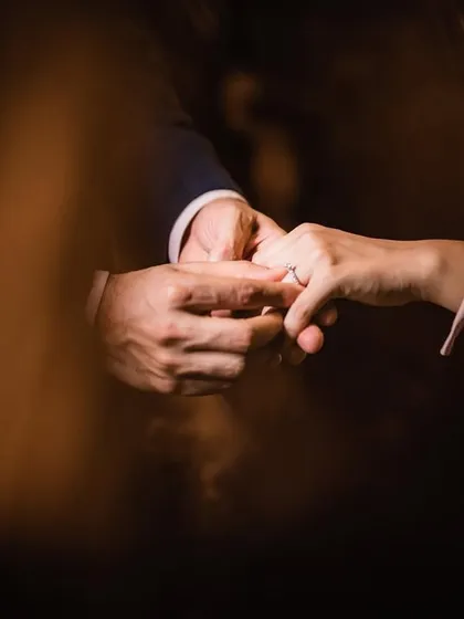 A close-up shot capturing the intimate moment of the ring exchange, a memory they will cherish forever.