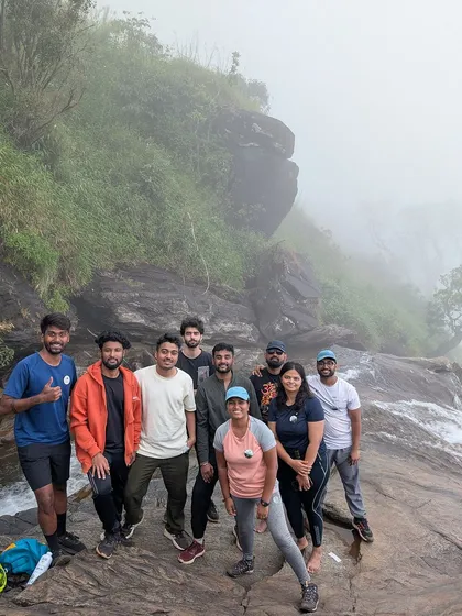 A group photo at the edge of the Bandaje waterfalls, a thrilling spot for a picture.