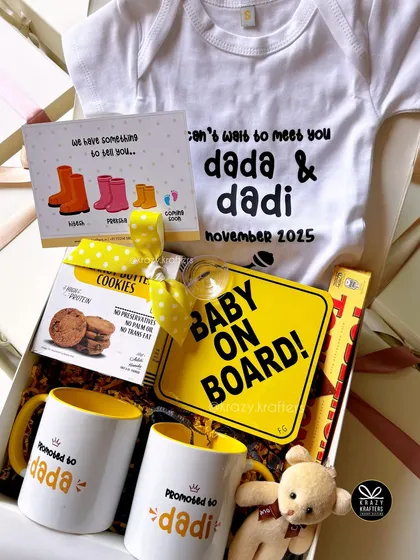 The sweetest way to share the best news! This pregnancy announcement hamper for the 'dada' and 'dadi' to be is filled with personalized mugs, a 'Baby on Board' sign, and a custom onesie to make the moment truly special.