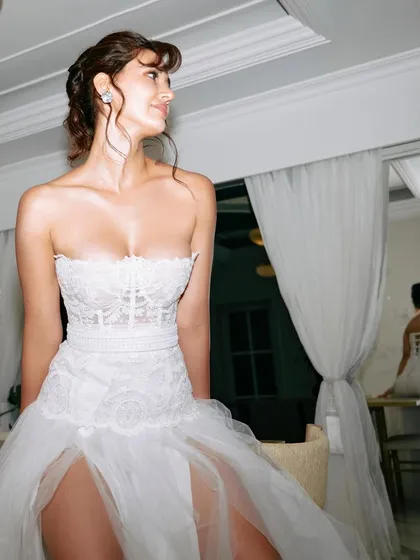 A profile view of the intricate updo I styled for Disha Patani. I love how the reflection in the mirror gives a second glimpse of the hairstyle's beautiful structure.
