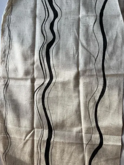 This is one of my favorite prints from the season, featuring hand-painted wavy lines on natural cotton. The organic, flowing design is created with a natural black pigment, perfect for modern and minimalist collections.