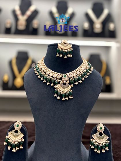 This green beaded choker set is a popular choice for mehendi functions. The colour pops beautifully, and the matching earrings and tikka complete the look.