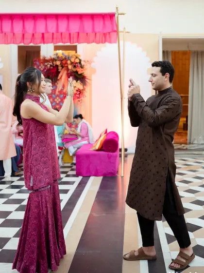 Guests capturing memories at the Mehendi function. We design our decor to be photo-worthy from every angle, creating plenty of Instagrammable spots.
