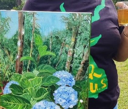 Holding my painting of blue hydrangeas in the very environment that inspired it. Painting on location, or 'en plein air', allows me to directly translate the feeling of a place onto the canvas.