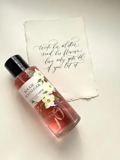This image showcases how I combine multiple art forms: hand-painting florals on a perfume bottle, engraving a name directly onto the glass, and creating a matching handwritten calligraphy note. It's the ultimate personalized gift.