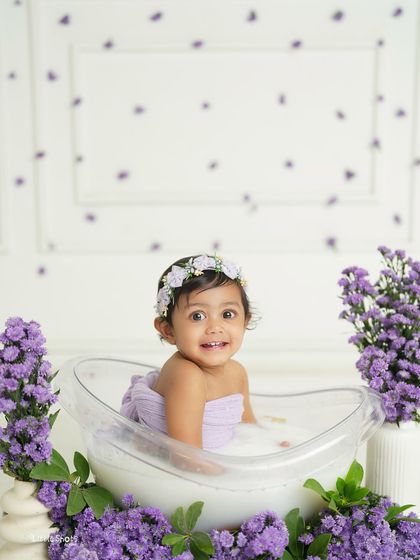 A serene moment in a tub full of lavender. This baby girl looks so peaceful and happy surrounded by the beautiful purple blossoms.