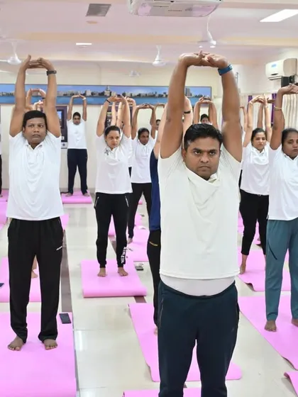 Mumbai Traffic Police officers practicing Tadasana (Mountain Pose) with an upward stretch. This simple pose helps improve posture and create a sense of groundedness.