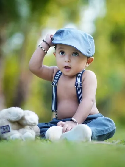 A dapper little boy in the park. Outdoor sessions allow for natural light and candid moments, perfect for capturing a child's personality.