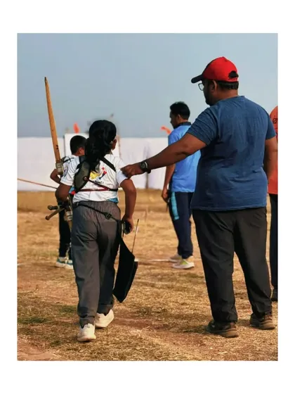 A coach and student celebrating a win at the Under 9 State Archery Championship. Mentorship is key to our process, guiding our youngest archers on their path.