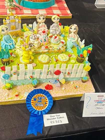 I poured my heart into this piece for the national Cakeology competition and was so proud to bring home the silver award. It’s a whimsical tea party with some of my favorite characters, and every tiny detail is sculpted from sugar.