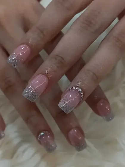 A classic pink and silver glitter ombré on square nails with rhinestone accents.