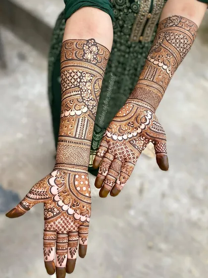 Full coverage mehendi for a special occasion. The design features a mix of floral, paisley, and geometric patterns, creating a rich and textured look.