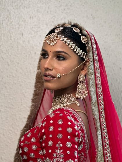 A side profile that highlights the intricate matha patti and nath.