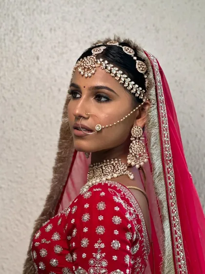 A side profile showcasing the intricate details of the matha patti and the soft, blended makeup. The skin looks flawless yet real, which is always my ultimate goal.