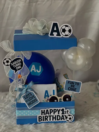 The complete football-themed first birthday hamper, all set up and ready to wow. The two-tiered design allows for plenty of gifts and a great presentation.