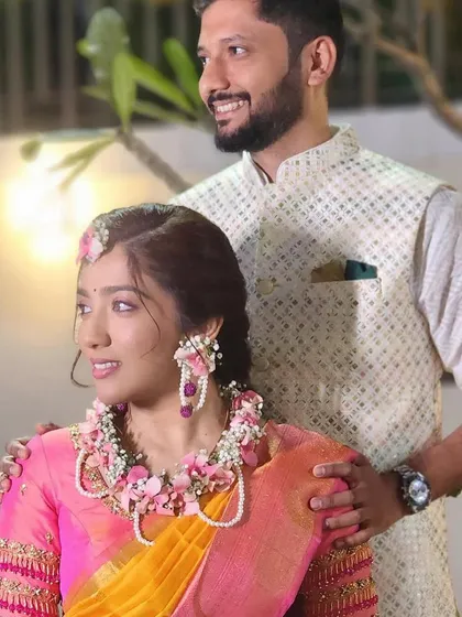 A lovely couple, with the bride wearing a beautiful pink floral jewellery set.